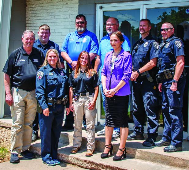 Olney Police Department Employees and Officers pose one last time with outgoing Olney Police Chief Dan Birbeck. Photo by Will Sadler