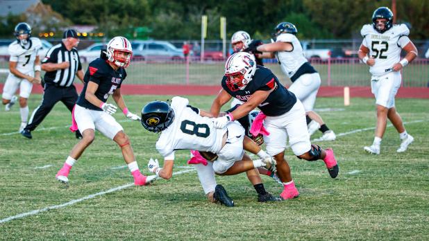 OHS Cub #52 Jacobi Esquivel DLOL brings down an Alvord Bulldog runner. Photo by Will Sadler