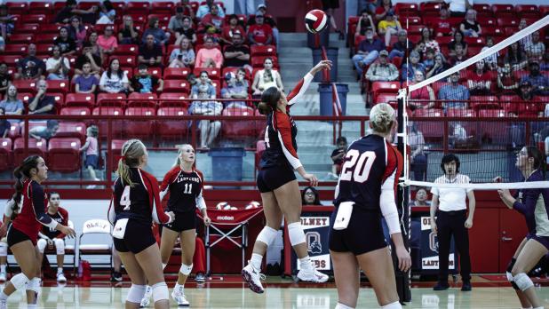 Lady Cub #14 Angel Turner is a very strong player at the net for the Lady Cubs, shown sending a volley over the net. | Photo by Will Sadler