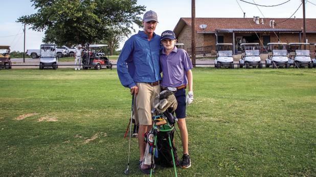 Dusty McElroy proudly poses for a photo op with son Christopher. Photo by Will Sadler