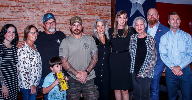 (Right): Family members, supporters and friends of Dustin Heard, Paul Slough, Nick Slatten and Evan Liberty lined up to get books signed at the Aug. 17 event at Hudson’s on Main in Olney, sponsored by the Olney Enterprise. (L-R): Dustin Heard’s sister