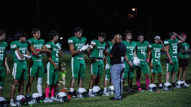 NHS Head Football Coach and Athletic Director Isaiah Archer addresses the Bobcats with last minute instructions before the district matchup with the Vernon Indians. Photo by Will Sadler