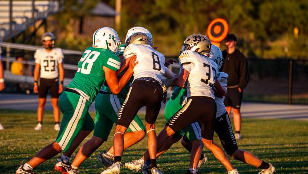 A big part of the successful JV Bobcat offense is the line, shown pressing the Jaybird defense and allowing the JV Bobcat runner the room he needs to cut through the defensive line. Photo by Will Sadler