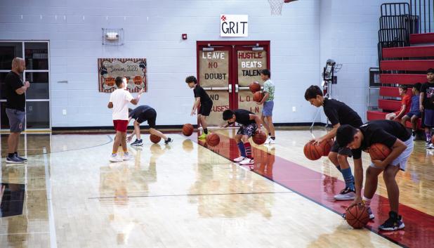 Cub Basketball Camp attendees must dribble a ball with each hand to be the last Cub dribbling to win. Photo by Will Sadler