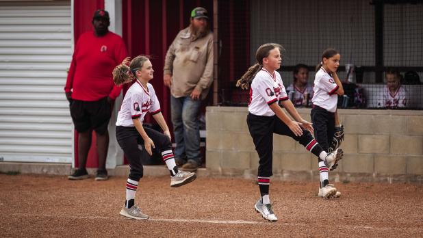 The Lady Cubs know that having fun is mandatory when playing softball in the summer, dancing is a great way to warm up as well. Photo by Will Sadler