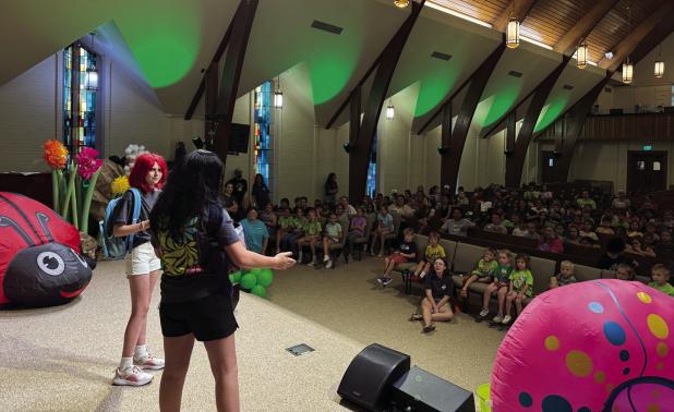 Leigha Hampton and Emerald Edgington performing a skit at FBCO’s “Magnified” Vacation Bible School worship rally in the sanctuary. Photo by FBCO