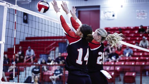 Lady Cubs #14 Angel Turner and #20 Natalie Simmons team up at the net to block against the Lady Indians. Photo by Will Sadler