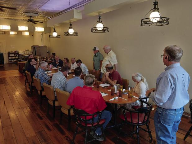 The OEDC board held a lunchtime meeting at Old Time Cafe to discuss an ambitous plan for 2026-27 fiscal year with state and federal officials, as well as structural engineers and city officials. Tom Parker (R) explains the plan to attendees. Photo by Gina