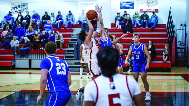 Cubs #13 Pedro Carreon continues to grow with the team and always shows tremendous heart and grit on the court. Shown driving to the basket for a floater. Photo by Will Sadler