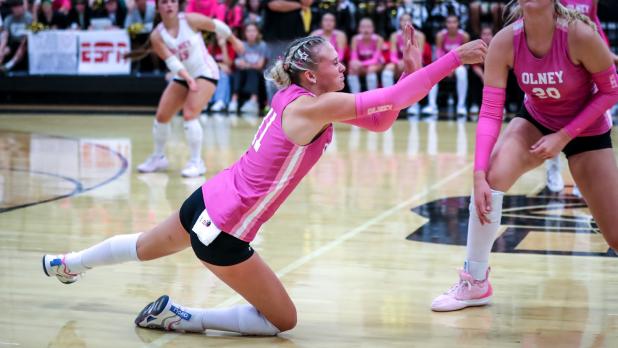 OHS Lady Cub #11 Kynlee Lauderdale with a dig against rival Archer City Ladycats in a district match.