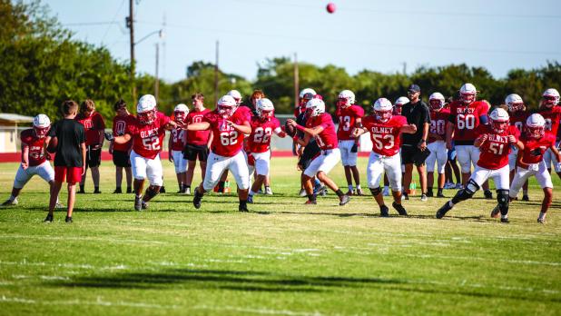 The Cubs Offensive line is confident this season, with a seasoned running back in Kyle Stewart. Cubs warming up before their scrimmage with the Eagles. Photo by Will Sadler