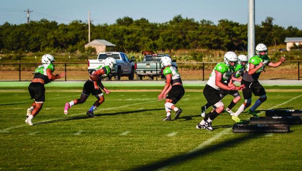 Bobcat offense runs offensive running drills; a successful season takes great passing and running. Photo by Will Sadler