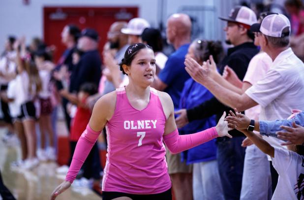 Lady Cub #7 Jalissa Whitlock makes her way around the court giving high fives to fans and family before their district game against the Trojanettes. Photo by Will Sadler