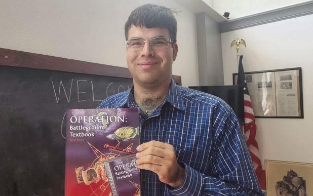 Local author touts science  book at school board