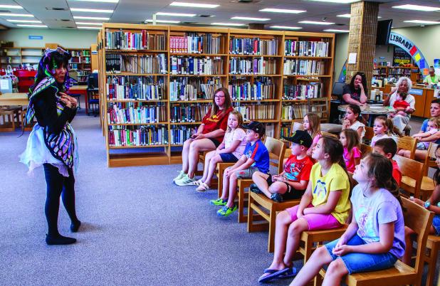 This summer OCLAC has been packed with eager children who enjoyed magic, storytellers and exotic animals as part of the many exciting summer programs this summer. Here Ms. Maria entertains children with a fun and lively story. Photo by Will Sadler