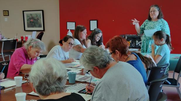Social worker Mona Bernhardt of Olney leads a lively seminar on color therapy as participants discussed their favorite colors and how - and whether - to stay within the lines. Photo by Gina Keating