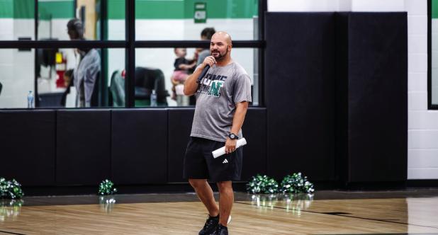 Newcastle ISD Athletic Director and Head Football Coach Isiah Archer gives a speech before players and attendees of Meet the Bobcats night. Photo by Will Sadler