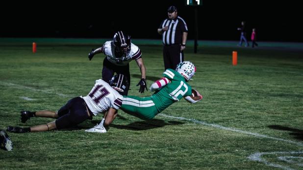 Bobcat #12 Mikey Soito gives maximum effort stretching out his arm to barely get the ball across the goal line, scoring for the Bobcats Photo by Will Sadler