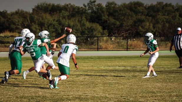 Bobcats scramble to get the play underway as May Tigers fly past the line. Photo by Will Sadler