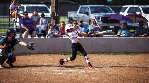 Lady Cub batter swings for the fences and comes away with a double. Photo by Will Sadler