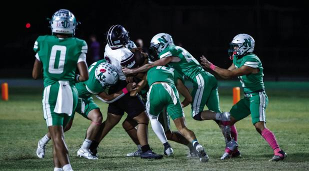 Bobcat defenders swarm a Vernon Indian during the district round. The Bobcat defense kept the Indians to 8 points before the game was called for severe weather leaving the Bobcats with a 46-8 win. Photo by Will Sadler