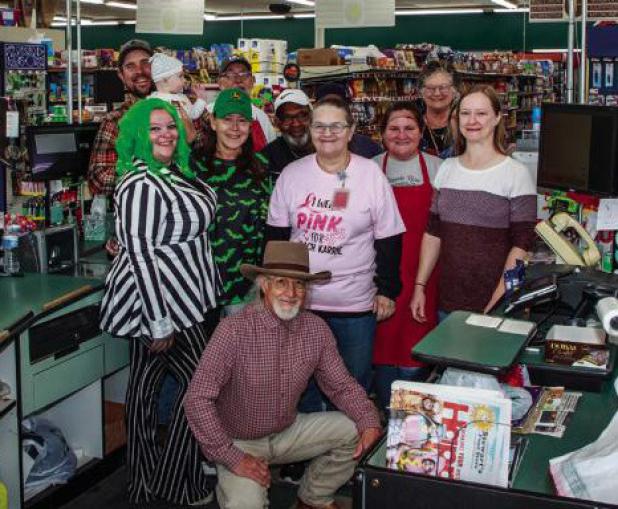 (Above): Stewart’s Food Store co-owner Robert Stewart poses with employees at the store founded by his parents, Harold and Faye Stewart. Robert Stewart runs Olney’s only grocery store with his brother, Danny, and son-in-law Jason Pack. Olney residents
