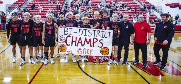 Olney High School Cubs and their coaches celebrate winning the Bi-District Championship in Mineral Wells on Feb. 23. The City of Olney practically shut down to travel to the game to watch the basketball Cubs win the honors, with the City Council and Olney