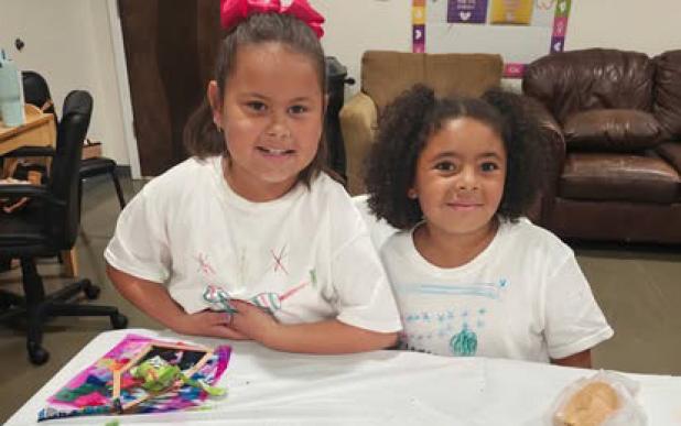 Two cooking camp attendees enjoy the fruits of their labors. Photo provided by The Refuge