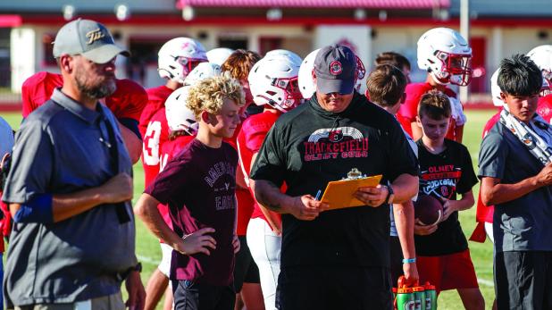 Son Ryan Keeter looks on at his dad, Coach Casey Keeter, with a proud look. Photo by Will Sadler
