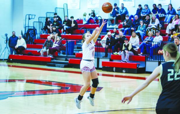 OHS Lady Cub #4 Mackenzie Berngen launches a bomb from outside the line for 3. Photo by Will Sadler