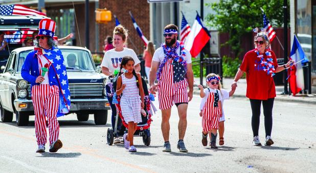The Refuge Olney Christian Community Center director Rodney Nance, (far left) dressed as Uncle Sam, parades down Main Street with his family on July 4 after winning Most Patriotic Citizen for the third year in a row. See Pages 8 and 10 for and more photos