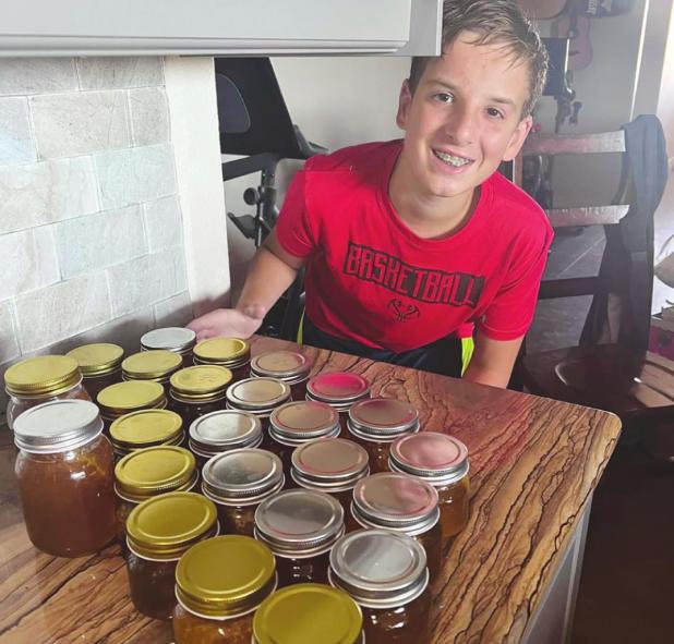 Young beekeeper checks in a year after starting his hive