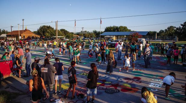 The Newcastle community showed up in force to help Newcastle ISD celebrate HOCO week. One loved tradition is painting the highway at the end of the HOCO Parade. Photo by Will Sadler