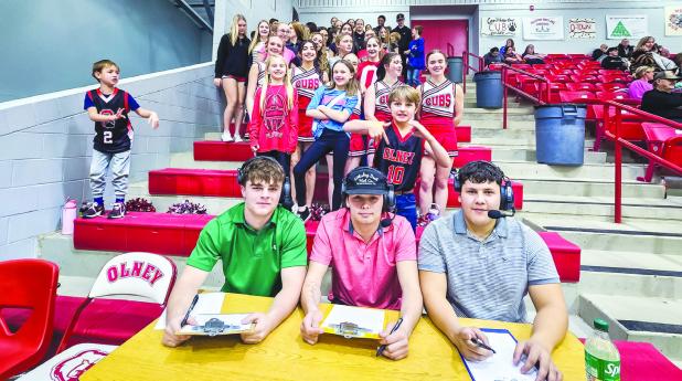 OHS Student Athletes head up the student cheering session with their own sports analyst and sportscaster table. [L-R] Kyle Stewart, Kanton Rodgers and Ricco Sandoval. Photo by Will Sadler