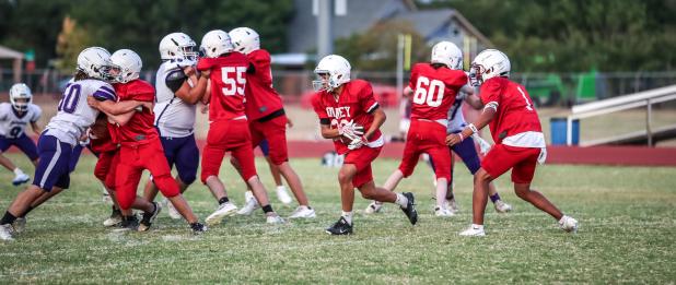 OJH Cub offensive line stands the Plowboy defense straight up, trying to hold them up while the Cub backfield has plenty of time to eye a route to the end zone. Photo by Will Sadler