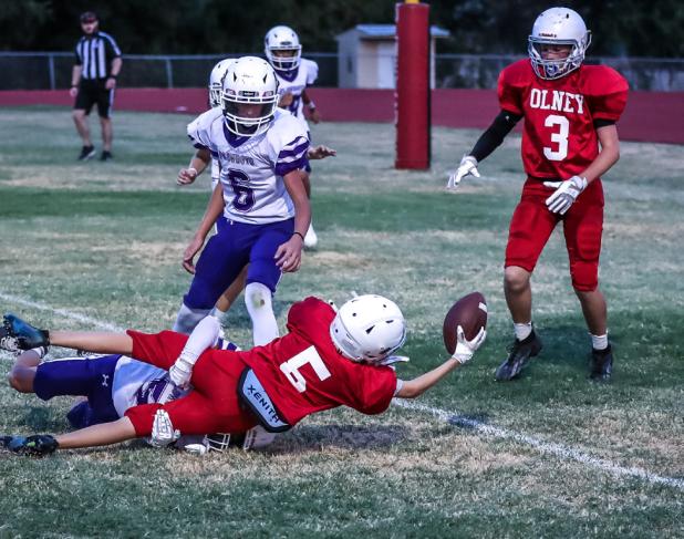 OJH Cub #5 Chris McElroy gives his all, and with a final stretch, the pigskin breaks the line! Photo by Will Sadler