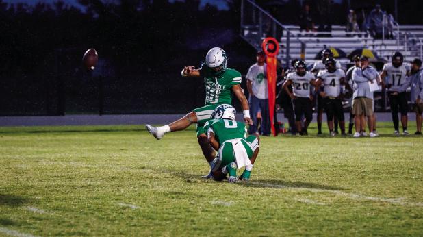 Bobcat #0 London Martinez held the snap for kicker #10 Keegen Voyles, the kick was one of many successful extra point kicks. The Bobcats go on to fold up the Wildcats 73-0 ending the game early then moving on to HOCO festivities. Photo by Will Sadler
