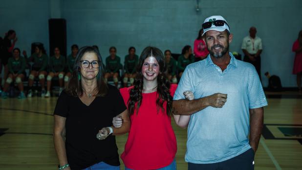 Jayla is escorted by parents Tricia and Michael Crossland during Senior night. Photo by Will Sadler