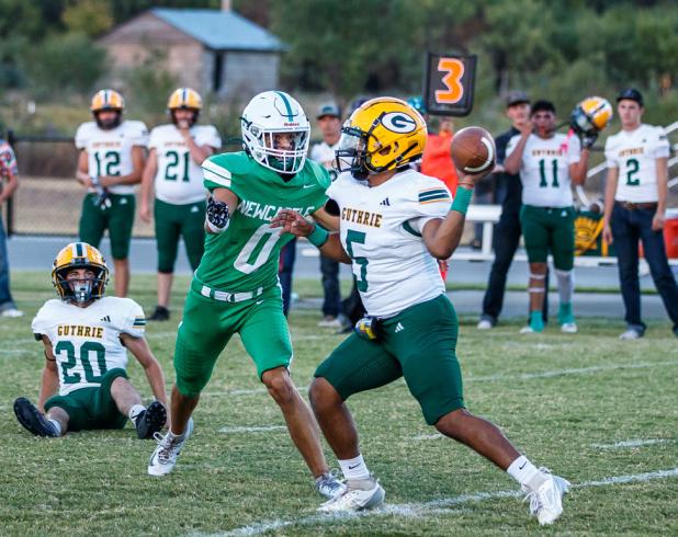 OHS Bobcat #0 Tristan Schultz RB/DE plows through the Jaguar line, leaving #20 Jaguar defender lying on the ground, wondering what the number of the bus that ran over him was. The Bobcat defense was too much for the Guthrie offense, leading to a 50-0 blow