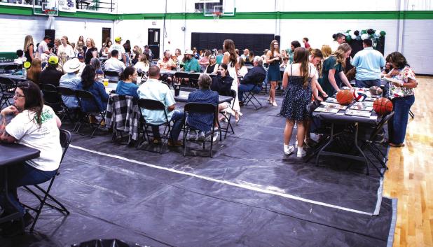 Attendees of the NHS Athletic Banquet enjoyed conversations and reliving memories of the past year of exciting sports events. The auction table was also a hot spot, the items auctioned included signed team photos, balls and other sports memorabilia of the