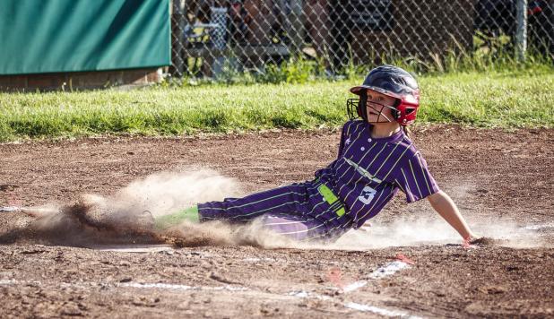 Olney Bomber slides into home plate advancing the team a run. Photo by Will Sadler