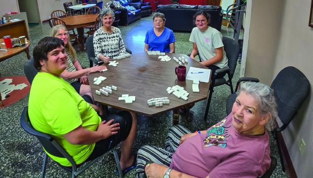 Cub Center guests enjoying a game of Chicken Foot pause to mark the occasion during the Cub Center June Game Night. Photo by Will Sadler