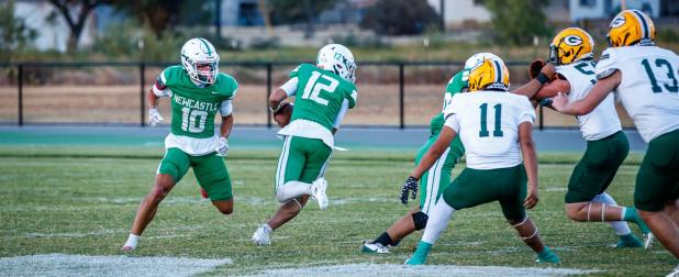 NHS Bobcat #12 Hunter Hill QB on the hunt (pardon the pun) for his pigskin missile downfield, which connects with #56 Cooper Clayton C/NG for a touchdown reception.