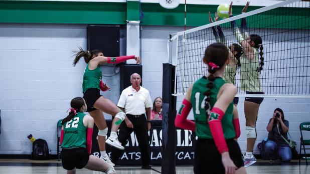 Ladycat #20 Kenzie King slams a kill shot between two Lady Pirate defenders at the net. Photo by Will Sadler