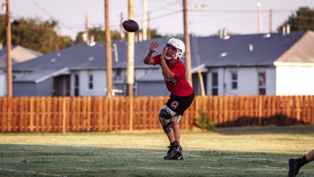 A Cub receiver practices running routes and catching. Photo by Will Sadler
