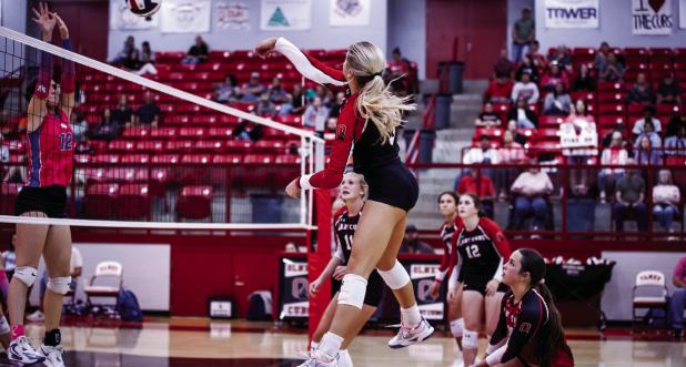 Lady Cub #3-Bradi Bowers sends a kill shot over the net towards Lady Trojan defenders. Photo by Will Sadler