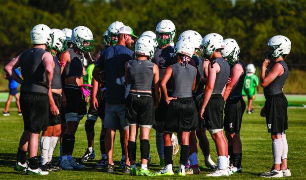 Assistant Football Coach/Head Boys Basketball Coach James King addresses Bobcat players during practice. Photo by Will Sadler