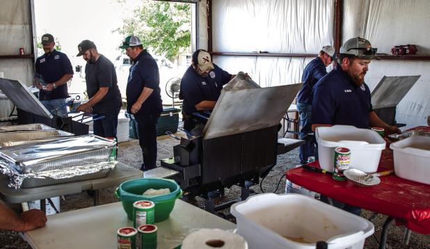 Fire Chief Kris Brice and Assistant Fire Chief Aaron Gowens, with the help of friends, family and volunteer firefighters, fed countless attendees during the Newcastle Fire Department’s only fundraiser of the year. Photo by Will Sadler