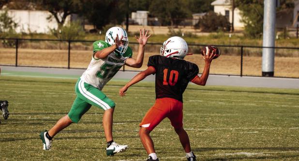 A Bobcat defender rushes the Rotan quarterback, who rushes the throw, which falls right into the hands of a Bobcat defender for an interception. Photo by Will Sadler
