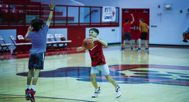 One of the activities of the basketball camp was a king of the hill shooting challenge, shooters got to keep shooting if they scored as other shooters rotated in to try to take over the basket from the holder. Photo by Will Sadler